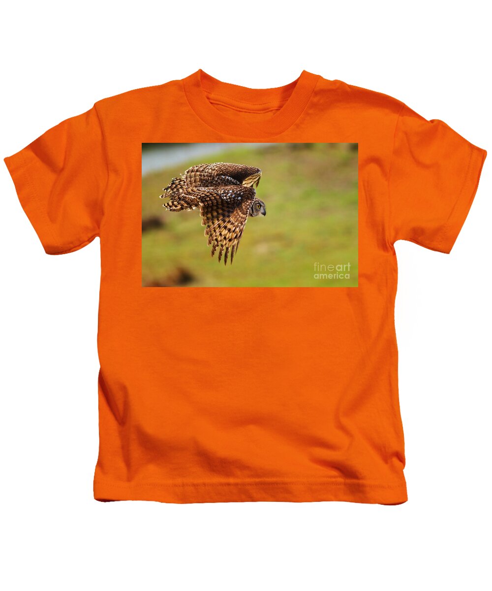 African Kids T-Shirt featuring the photograph Spotted Eagle Owl in flight #2 by Nick Biemans