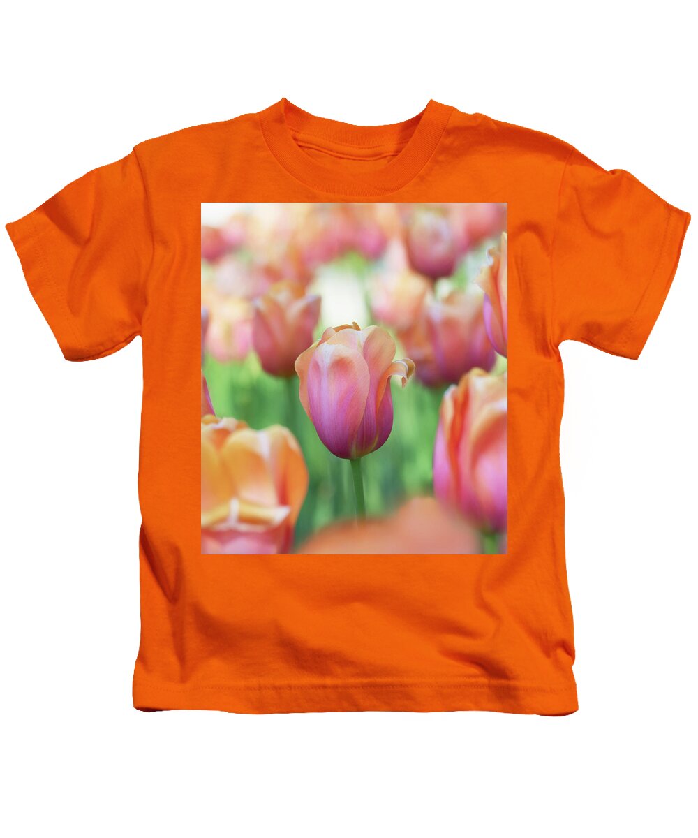 Beautiful Kids T-Shirt featuring the photograph A bed of tulips is a feast for the eyes. by Usha Peddamatham