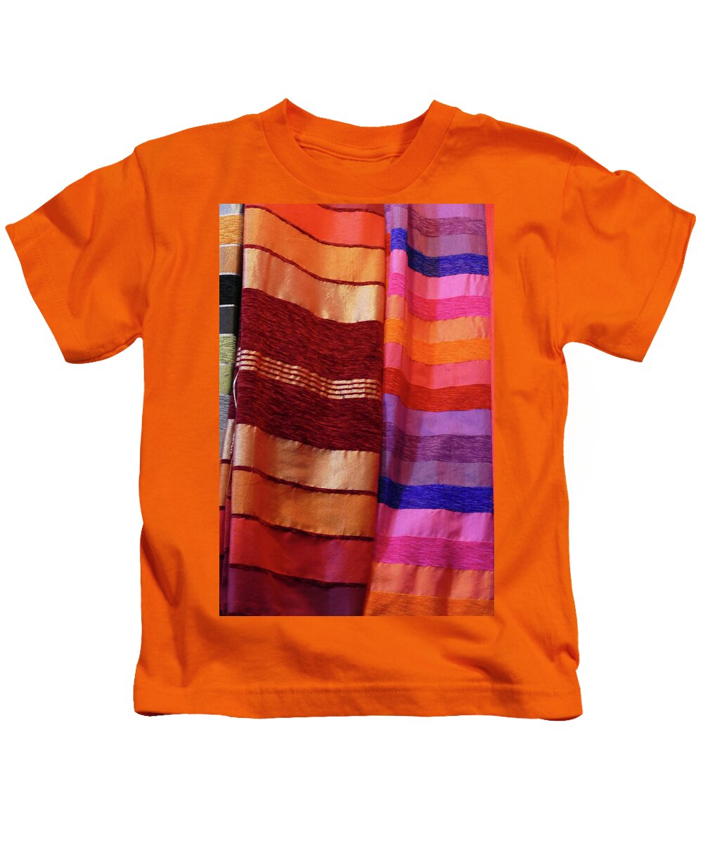 Marrakech Kids T-Shirt featuring the photograph Colorful fabrics in the medina market by Steve Estvanik