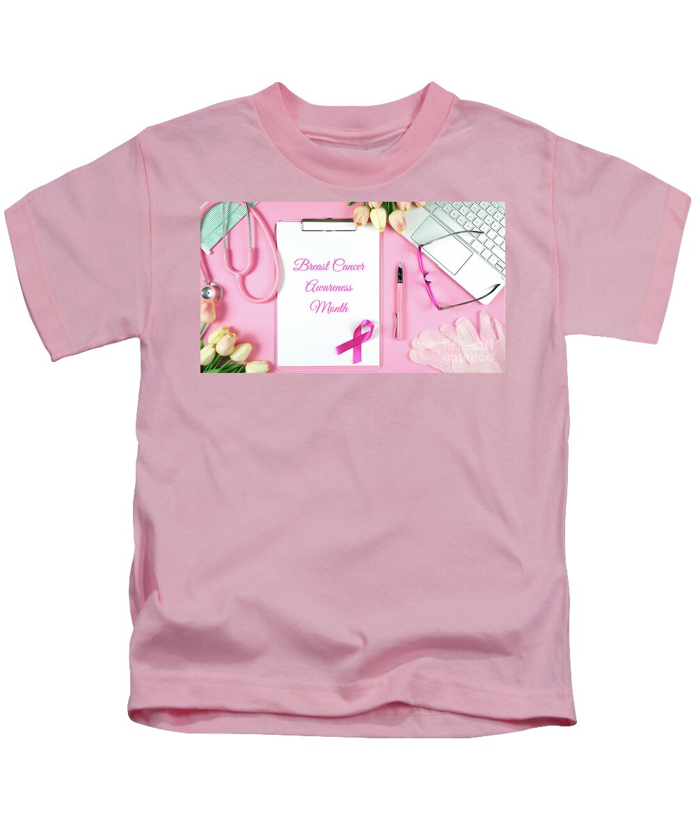 Pink Ribbon Kids T-Shirt featuring the photograph Pink Ribbon Breast Cancer Awareness Month doctor's desk concept. #1 by Milleflore Images