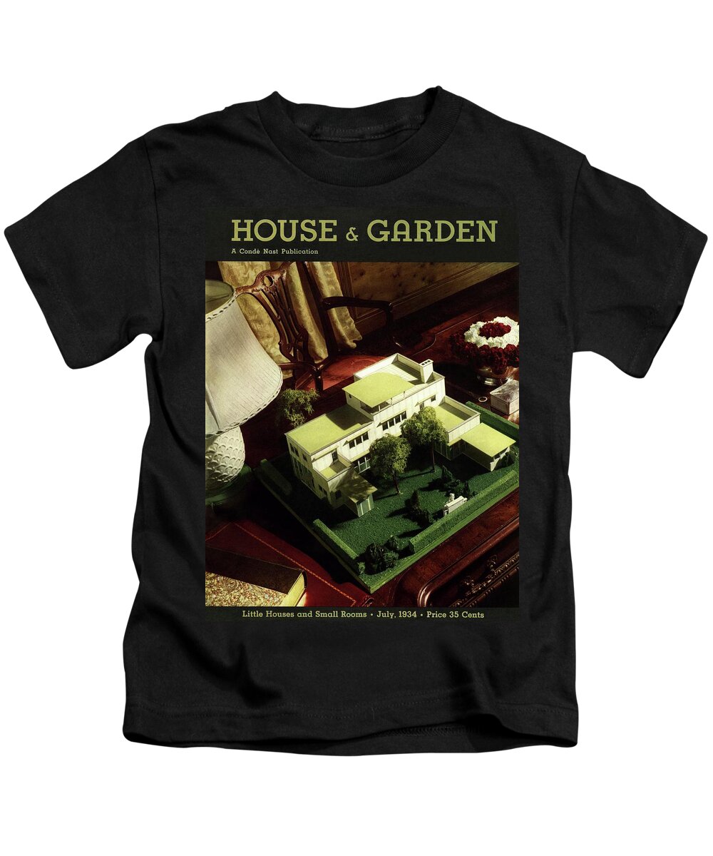 Still Life Kids T-Shirt featuring the photograph A House And Garden Cover Of A Model House by Anton Bruehl