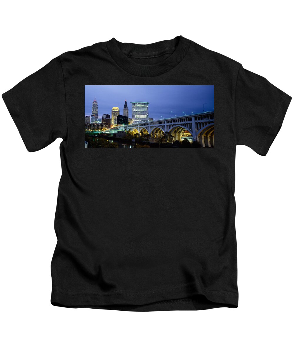 Photography Kids T-Shirt featuring the photograph Bridge In A City Lit Up At Dusk by Panoramic Images