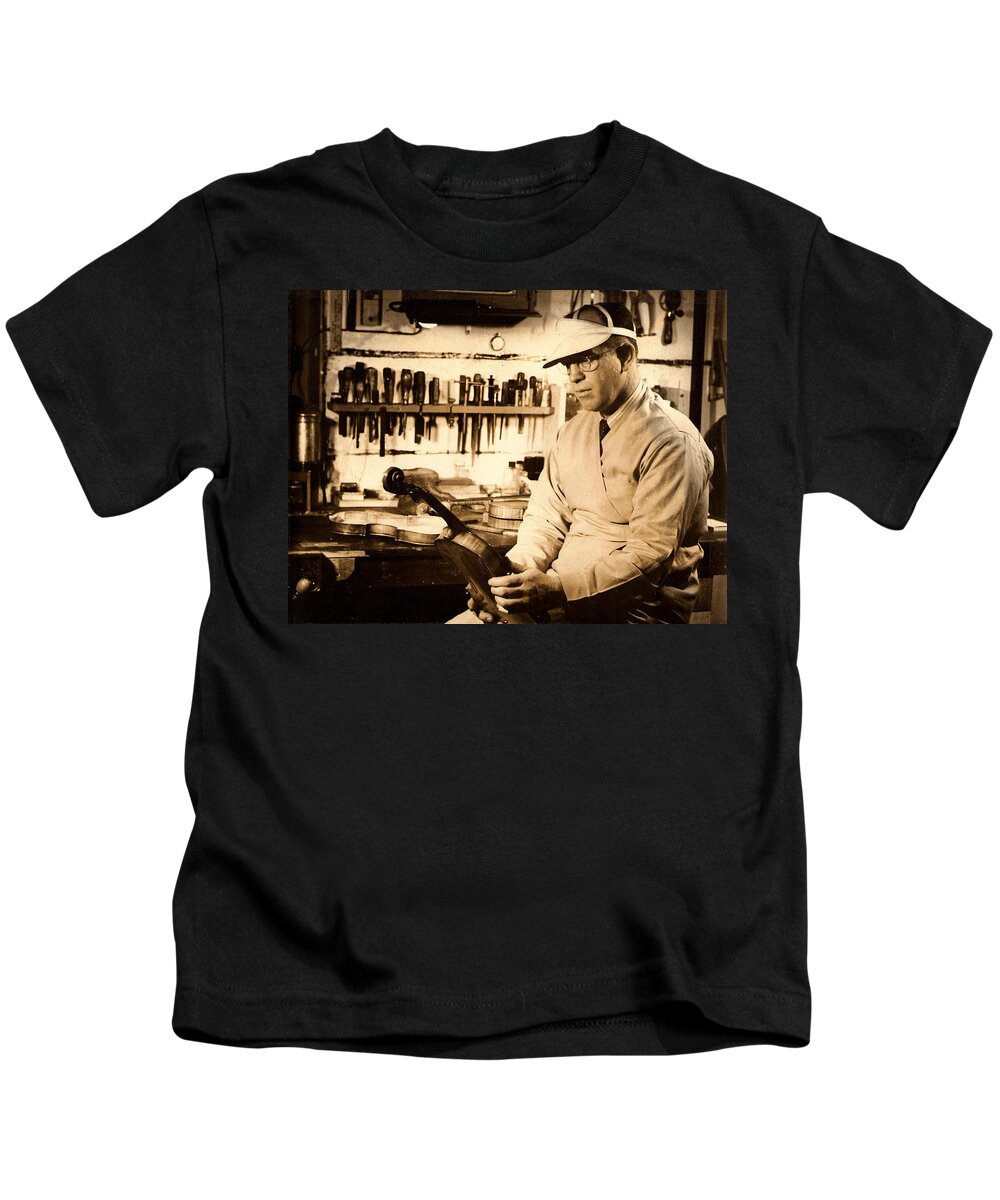 The Violin Maker Kids T-Shirt featuring the photograph The Violin Maker by Kiki Art