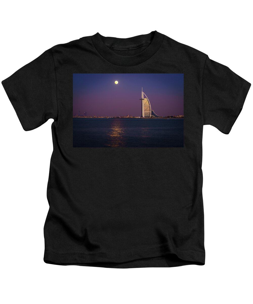 Burj Al Arab Kids T-Shirt featuring the photograph Moonrise over Burj Al Arab #1 by Alexey Stiop
