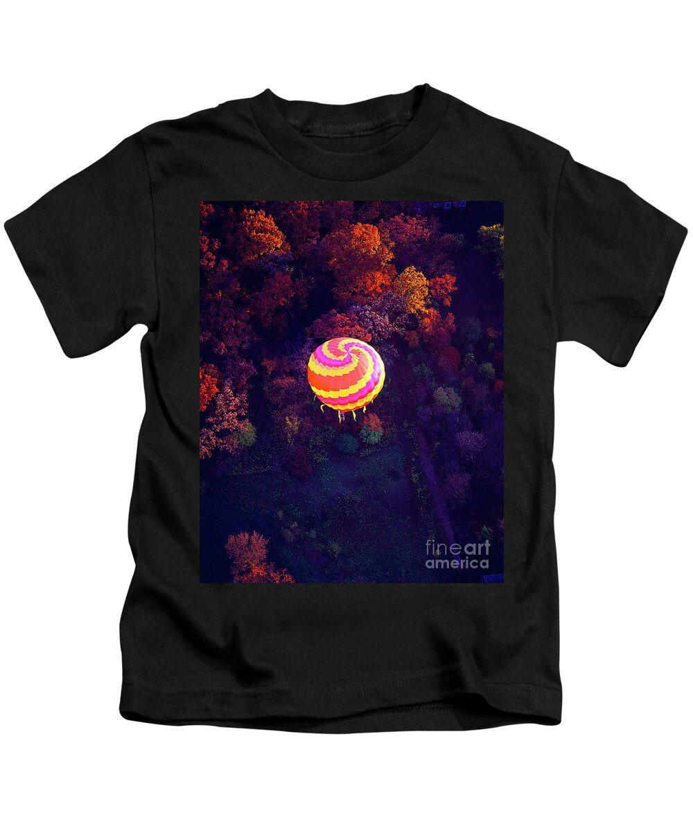 Spiral Kids T-Shirt featuring the photograph Spiral colored hot air balloon over fall tree tops Mchenry  by Tom Jelen