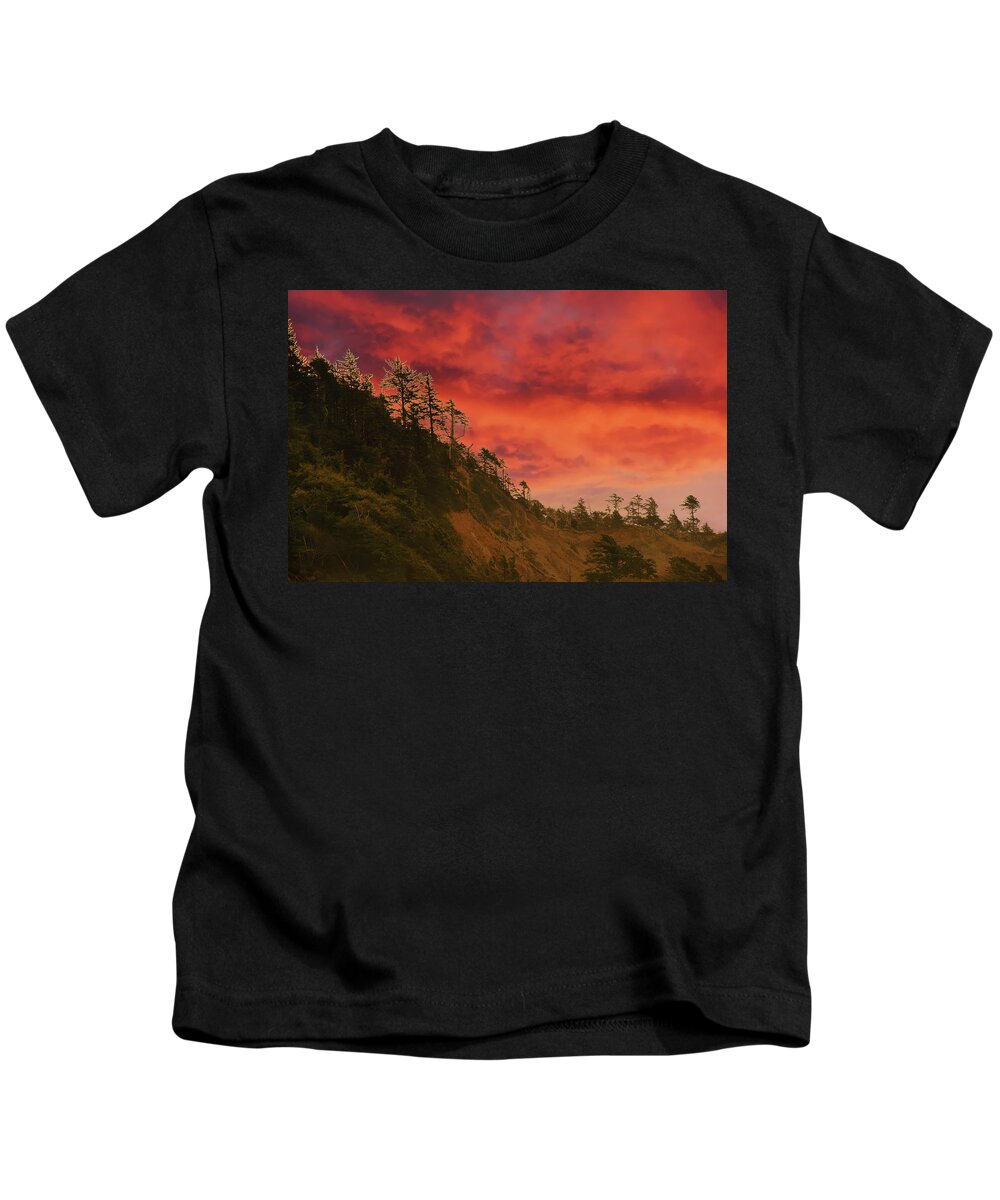 Cannon Beach Kids T-Shirt featuring the photograph Silhouette of conifer against seacoast by Steve Estvanik