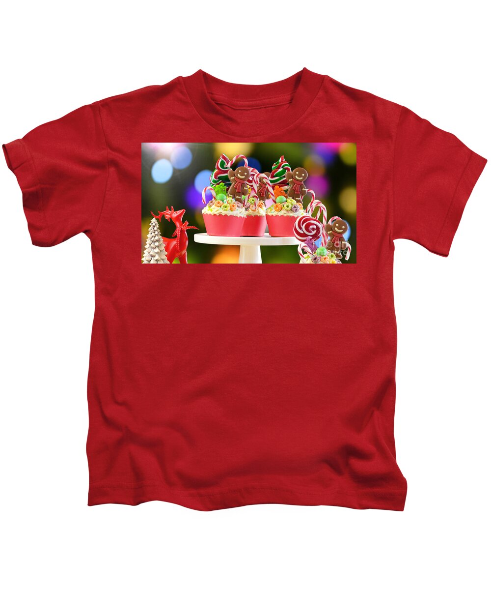 Christmas Kids T-Shirt featuring the photograph On trend candy land festive Christmas cupcakes. by Milleflore Images