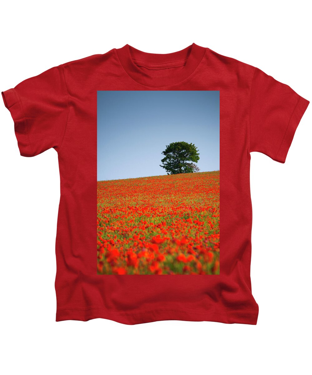 Alan Copson Kids T-Shirt featuring the photograph Tree in a Poppy Field by Alan Copson