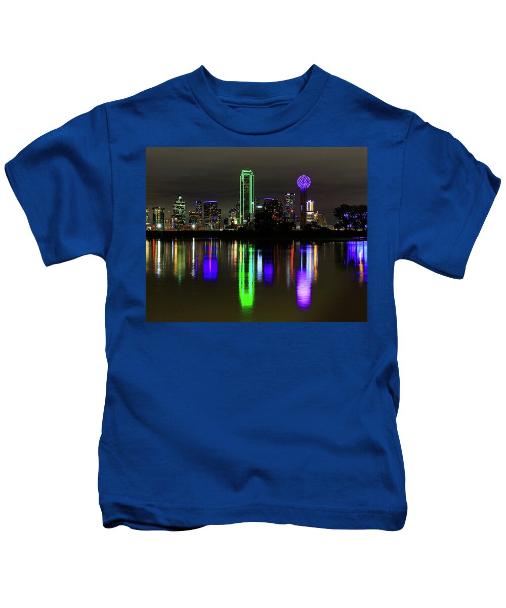  Kids T-Shirt featuring the photograph Dallas Texas skyline and the flooded trinity river with reflections and a purple Reunion Tower by David Ilzhoefer