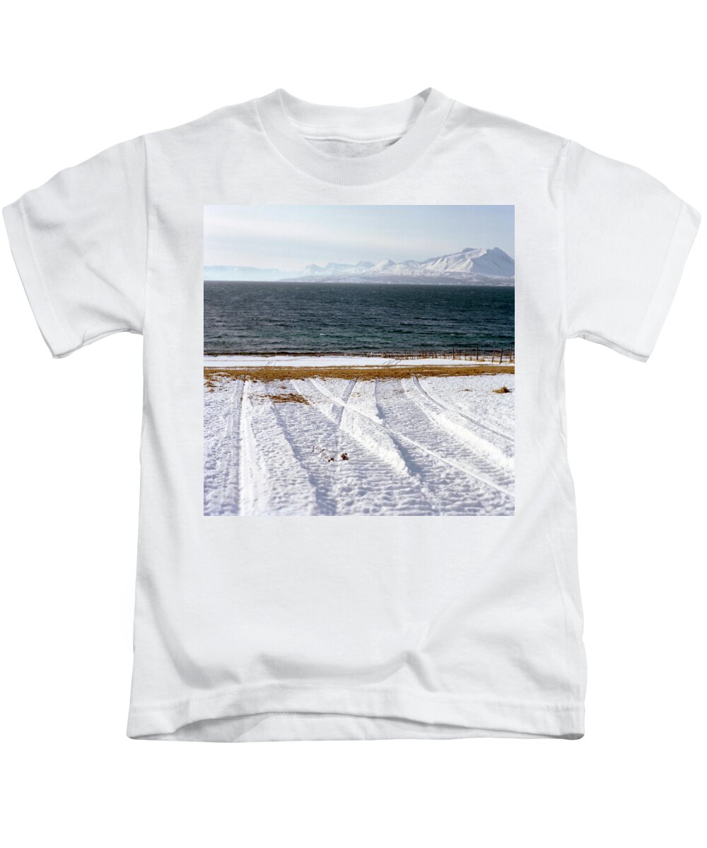 Coast Kids T-Shirt featuring the photograph The Lyngen Alps And Snowmobile Tracks by Kari Medig