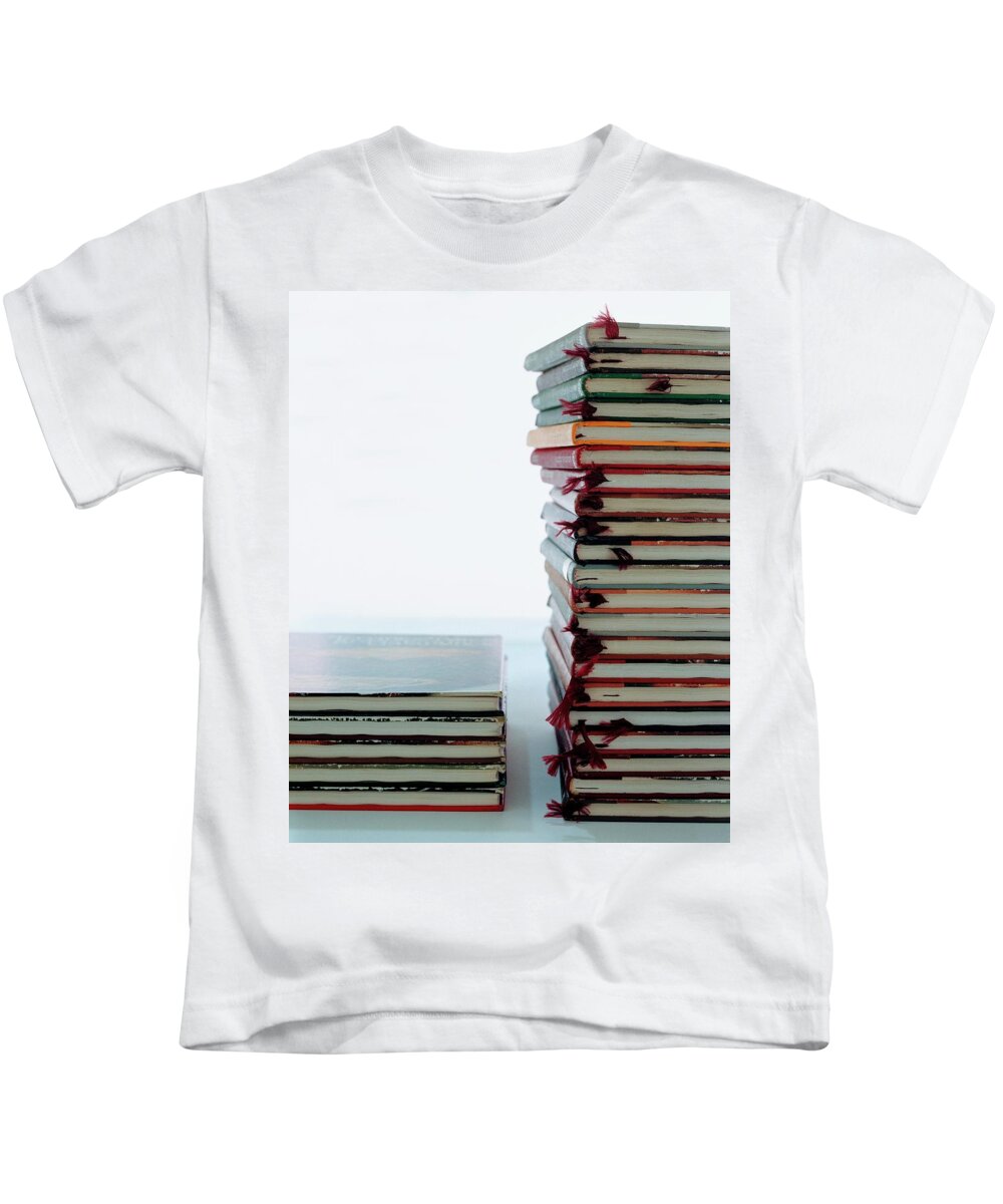 Arts Kids T-Shirt featuring the photograph Two Stacks Of Books by Romulo Yanes