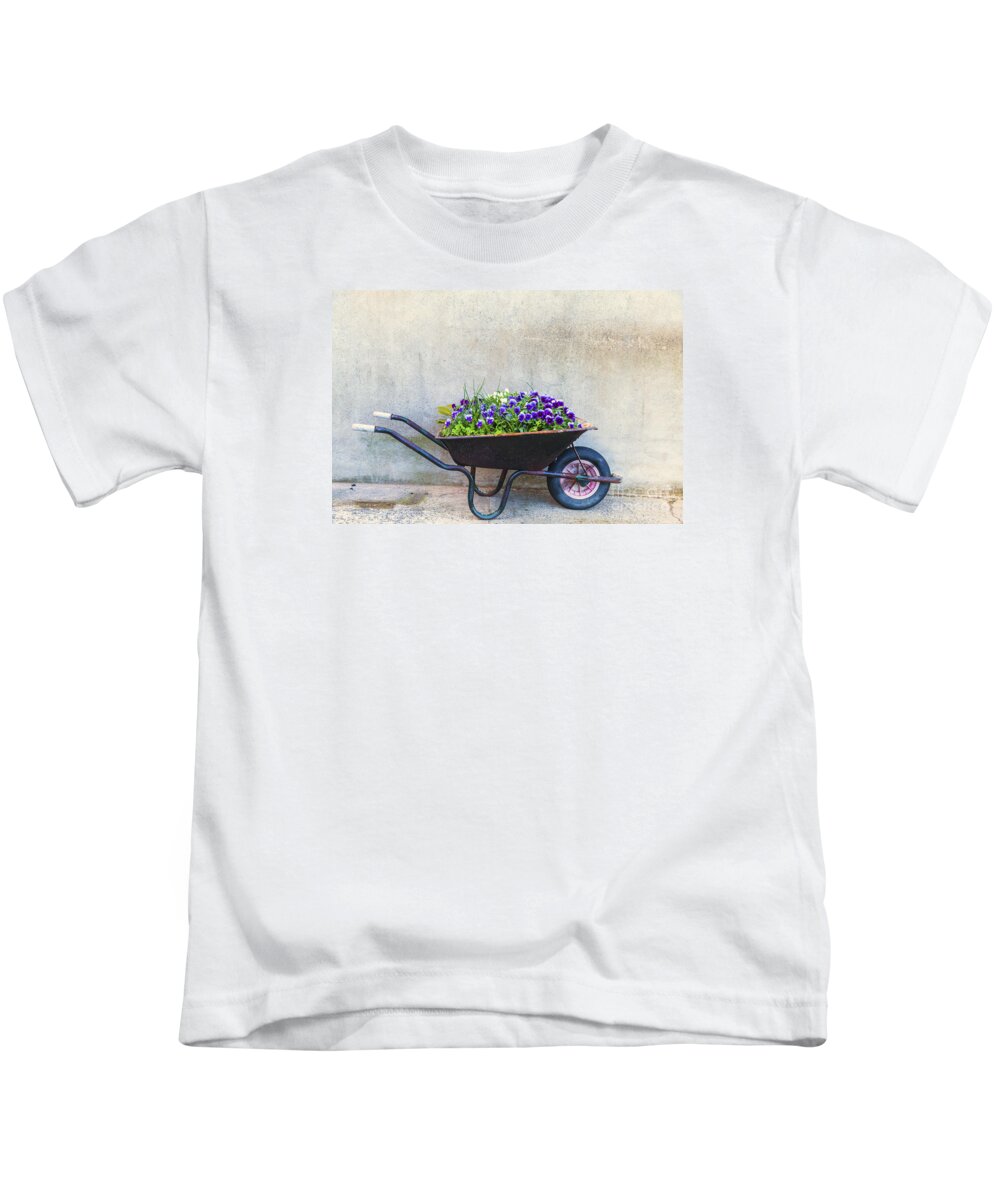 Cement Kids T-Shirt featuring the photograph Flowers in a wheelbarrow by Jim Orr