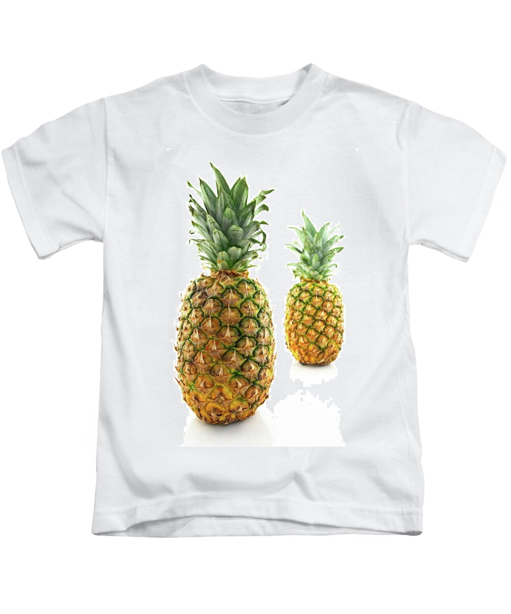 Pineapple Kids T-Shirt featuring the photograph Two ripe pineapples, focus on the closest one by GoodMood Art