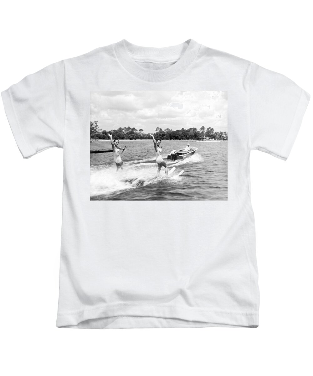 1950s Kids T-Shirt featuring the photograph Women Water Skiers Waving by Underwood Archives