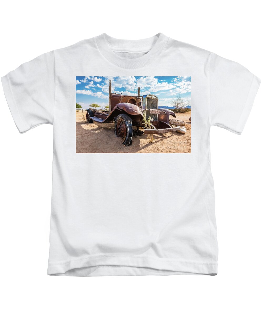 Car Kids T-Shirt featuring the photograph Old and abandoned car #3 in Solitaire, Namibia by Lyl Dil Creations