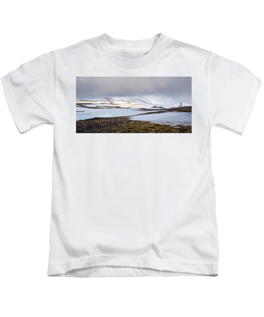 Iceland Kids T-Shirt featuring the photograph Icelandic landscape with mountains and meadow land covered in snow. Iceland #1 by Michalakis Ppalis