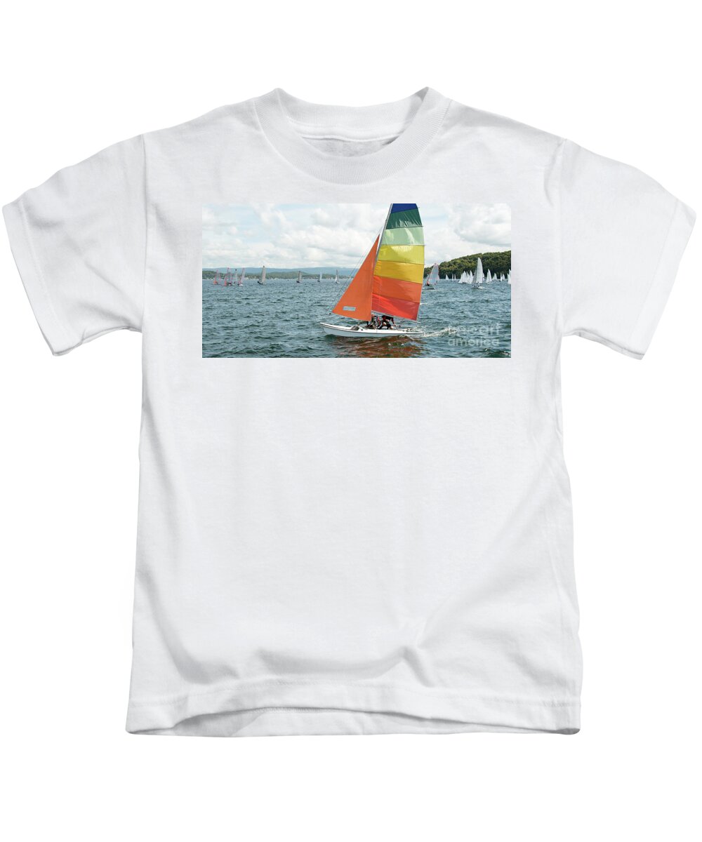Csne26 Kids T-Shirt featuring the photograph Childern racing sailing a small catamaran sailboat with colourfu by Geoff Childs