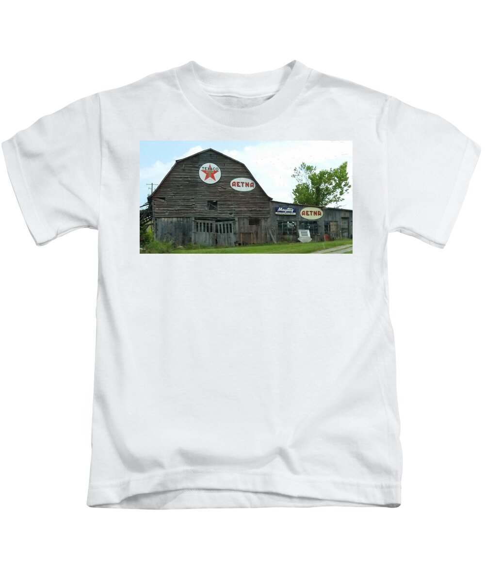 Old Kids T-Shirt featuring the photograph Weathered Dilapidated Store or Barn with Vintage Signage by Ali Baucom