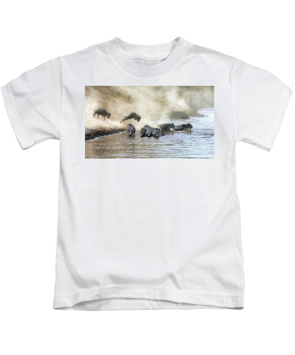 Motion Kids T-Shirt featuring the photograph Wildebeest and zebra cross the Mara River during the annual gre by Jane Rix
