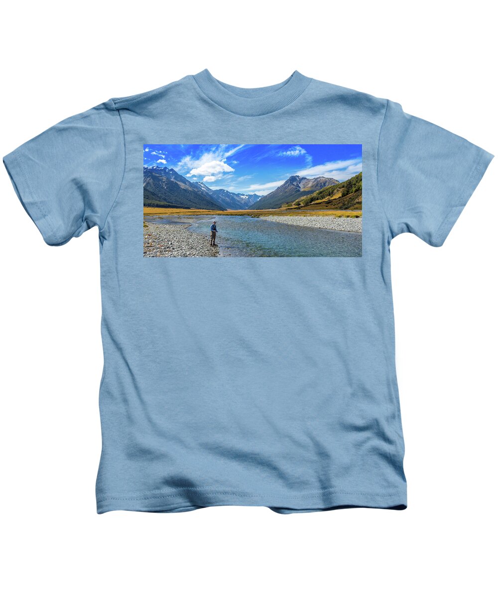 An Angler fly fishing for trout on the Ahuriri river, surrounded by  mountains Kids T-Shirt by Snap-T Photography - Pixels