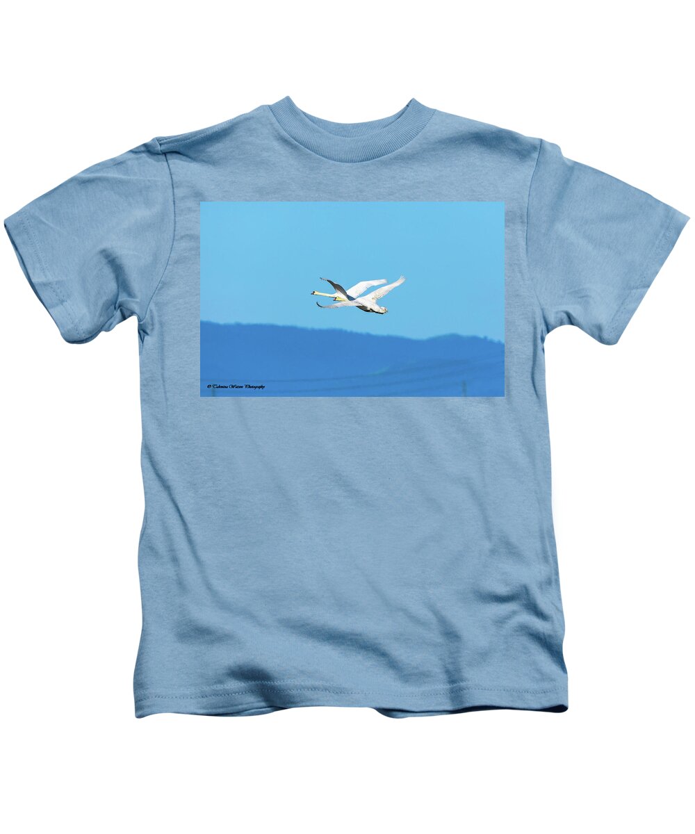 Swans Kids T-Shirt featuring the photograph Mute swans in flight by Tahmina Watson