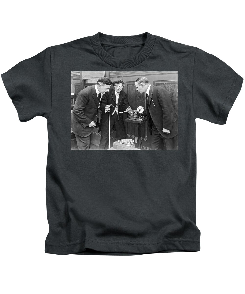 1035-1110 Kids T-Shirt featuring the photograph Brokers Checking Ticker Tape by Underwood Archives