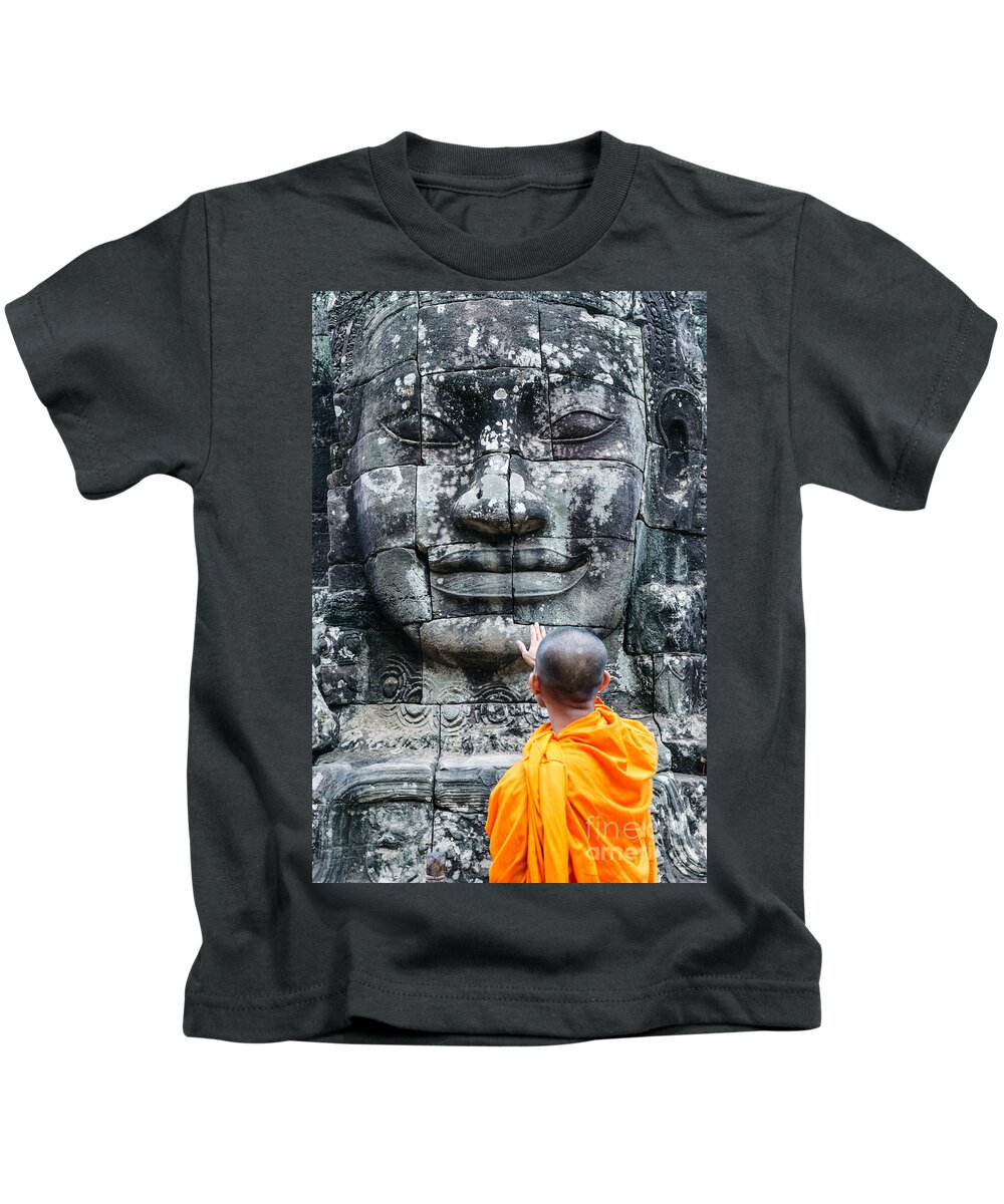 Buddha Kids T-Shirt featuring the photograph Cambodia - Angkor Wat - Monk touching giant Buddha statue by Matteo Colombo