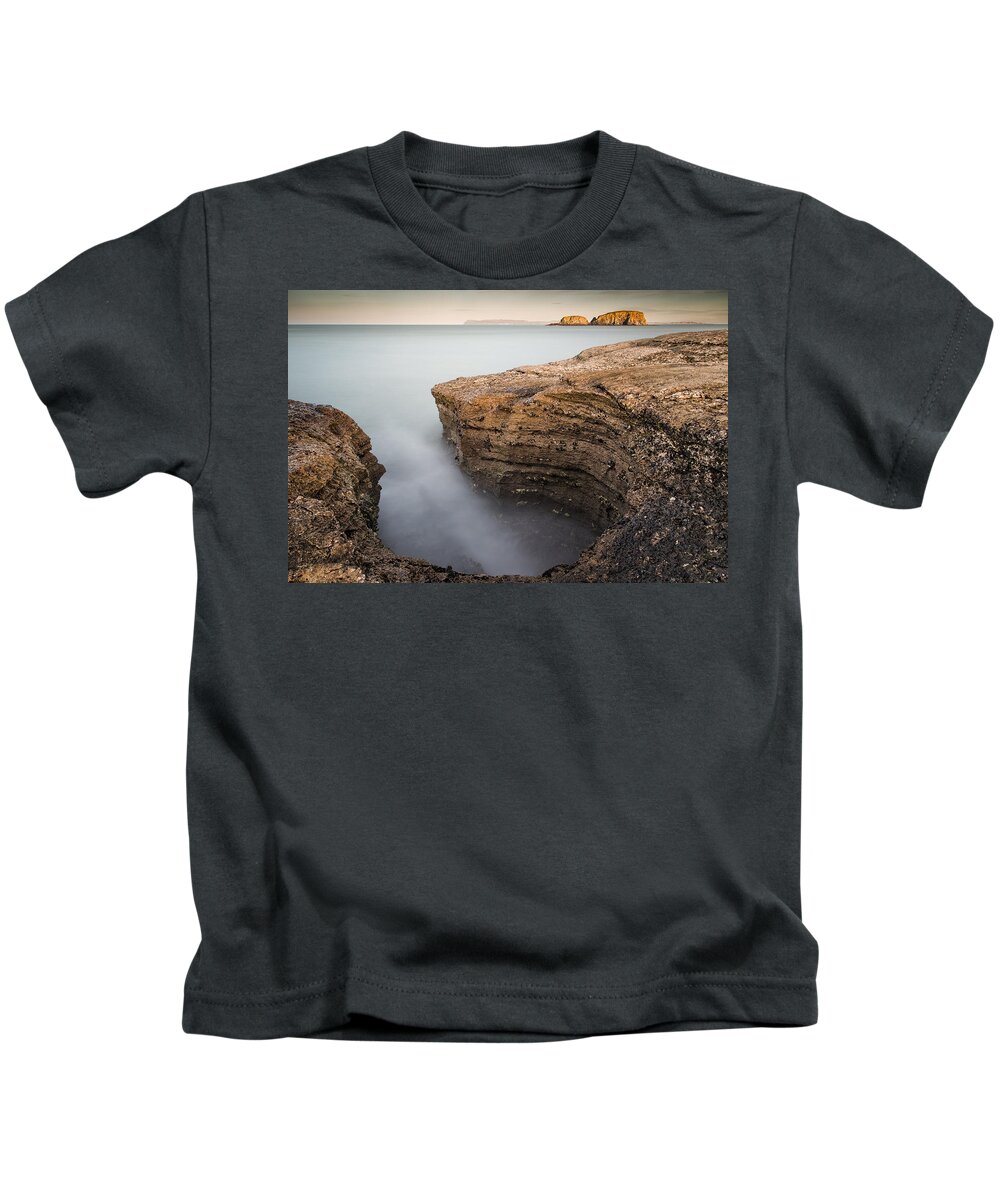 Sheep Island Kids T-Shirt featuring the photograph Carved by the Sea - Ballintoy by Nigel R Bell