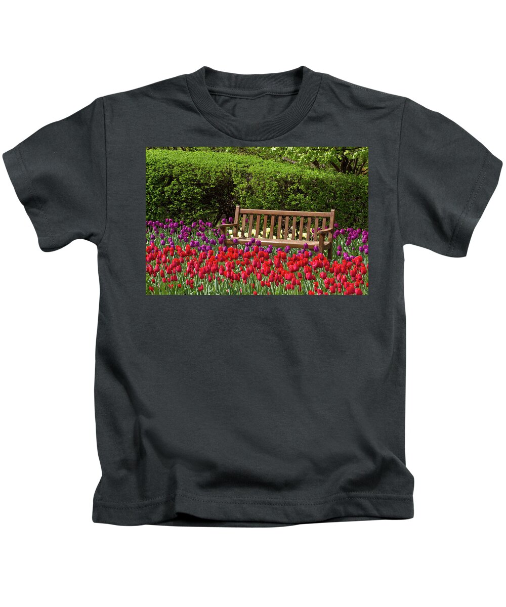 Photography Kids T-Shirt featuring the photograph Close-up Of Bench In Bed Of Tulips by Panoramic Images