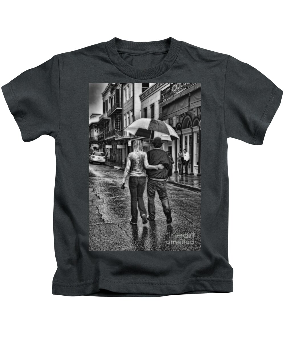 Walking Kids T-Shirt featuring the photograph Rainy French Quarter Stroll in black and white by Kathleen K Parker