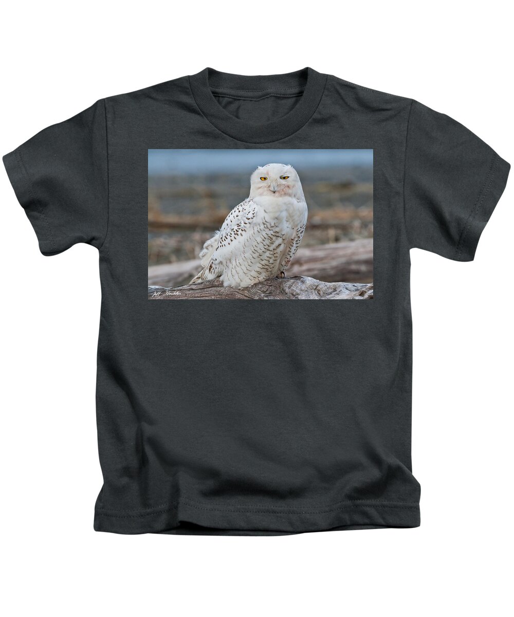 Animal Kids T-Shirt featuring the photograph Snowy Owl Watching from a Driftwood Perch by Jeff Goulden