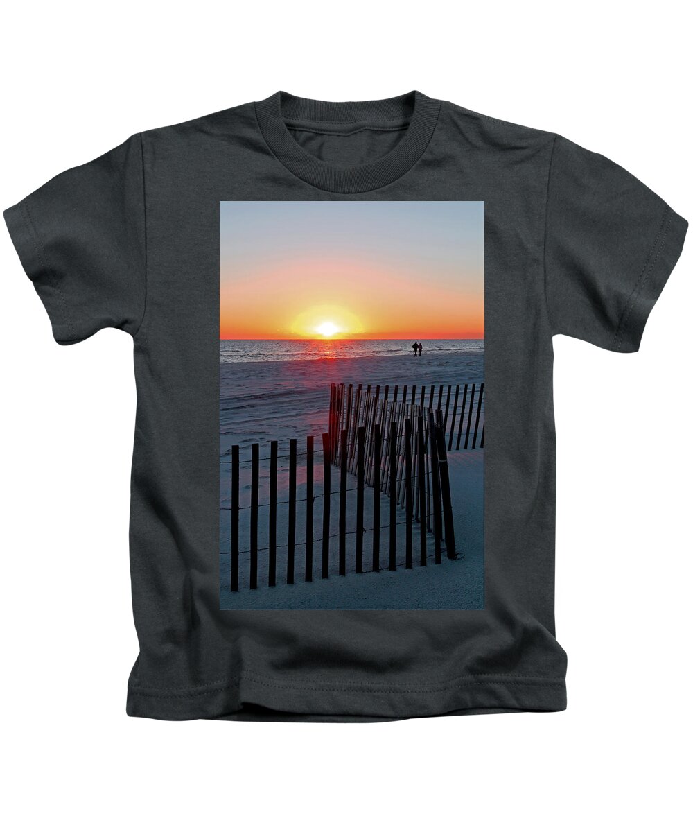 Sunrise Kids T-Shirt featuring the photograph Strolling Under an Orange Glow by Jennifer Robin