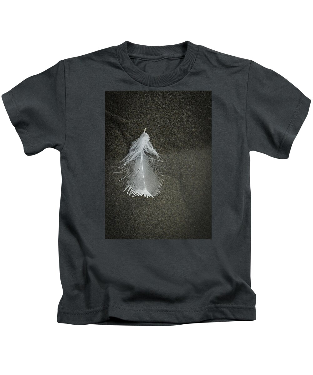 Feather Kids T-Shirt featuring the photograph A Feather at the Edge of the Water by Robert Potts