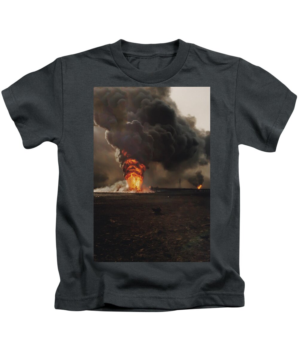 Aftermath Kids T-Shirt featuring the photograph Burning oil well fires in field with oil slick, Kuwait by Karen Foley