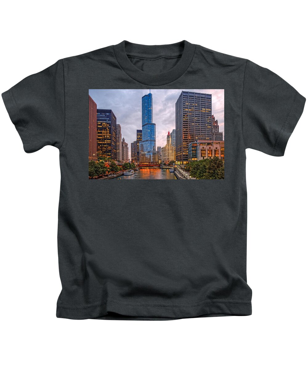 City Kids T-Shirt featuring the photograph Chicago Riverwalk Equitable Wrigley Building and Trump International Tower and Hotel at Sunset by Silvio Ligutti