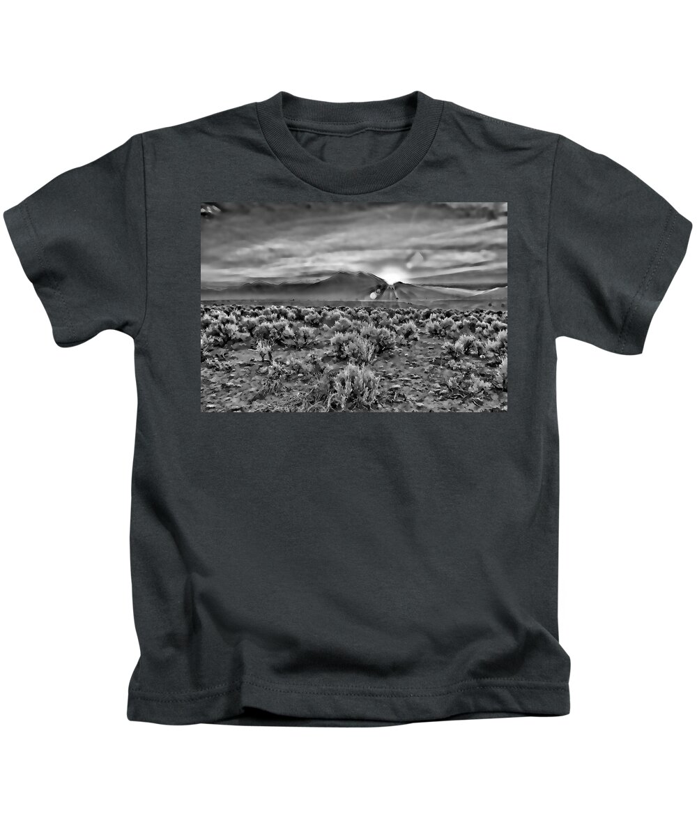  Dawn Kids T-Shirt featuring the digital art Dawn over magic Taos in b-w by Charles Muhle