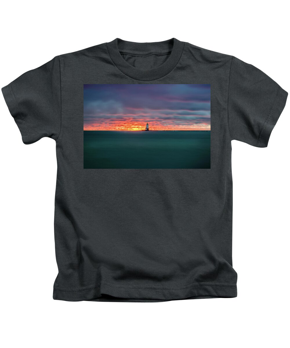 Ludington Mi Kids T-Shirt featuring the photograph Glowing Sunset on Lake With Lighthouse by Lester Plank