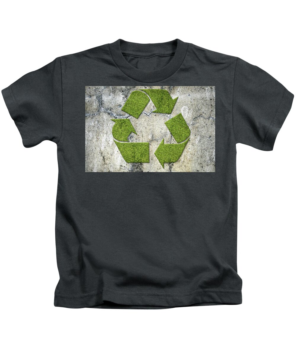 Recycling Kids T-Shirt featuring the photograph Green recycling sign on a concrete wall by GoodMood Art