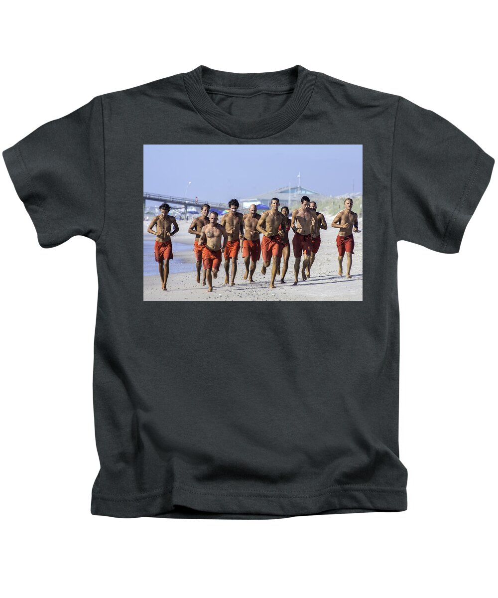  Life Guard Kids T-Shirt featuring the photograph Kure Beach Life guards on the run by WAZgriffin Digital