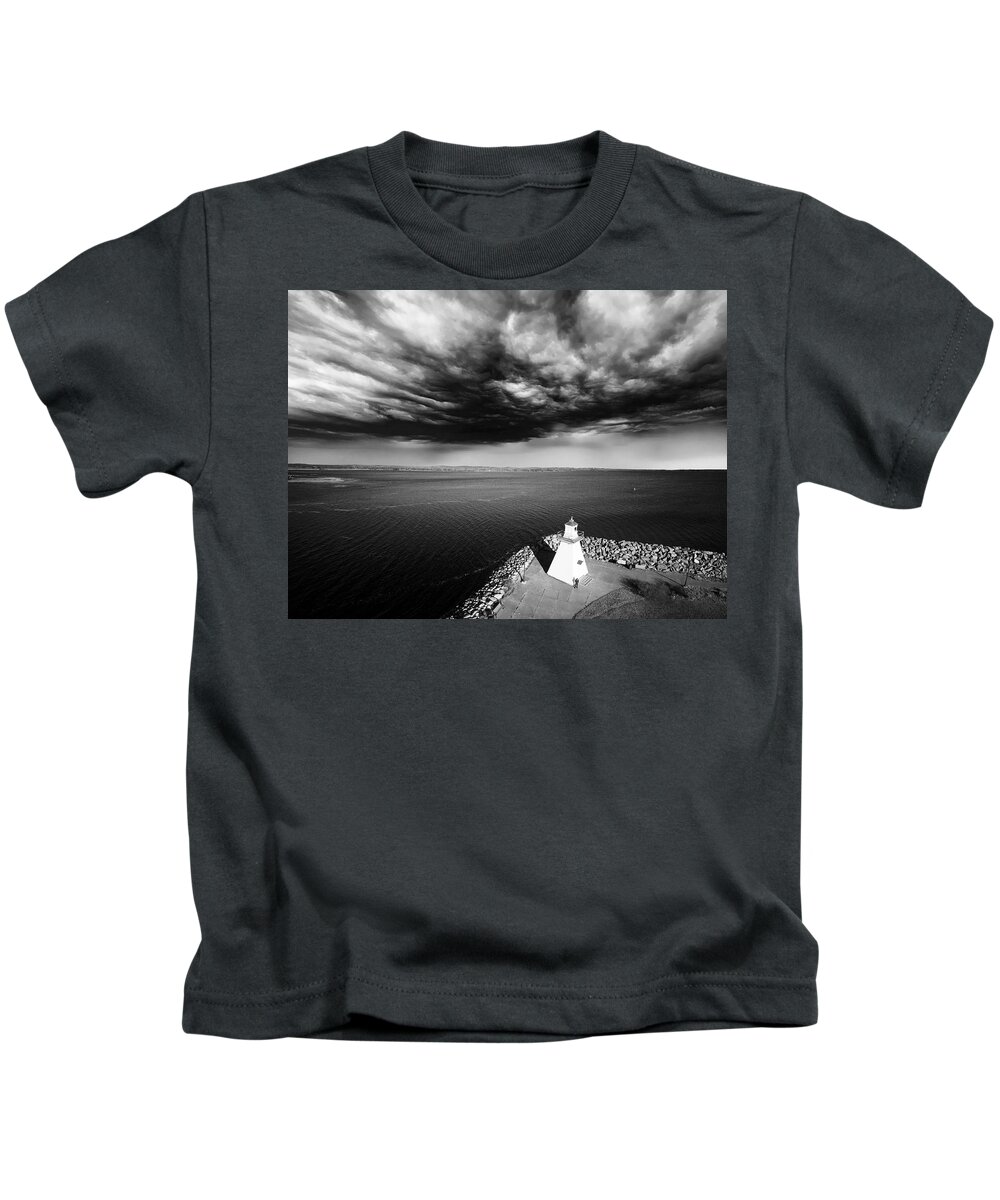 Lighthouse Kids T-Shirt featuring the digital art Storm Clouds Over a Lighthouse by Julius Reque