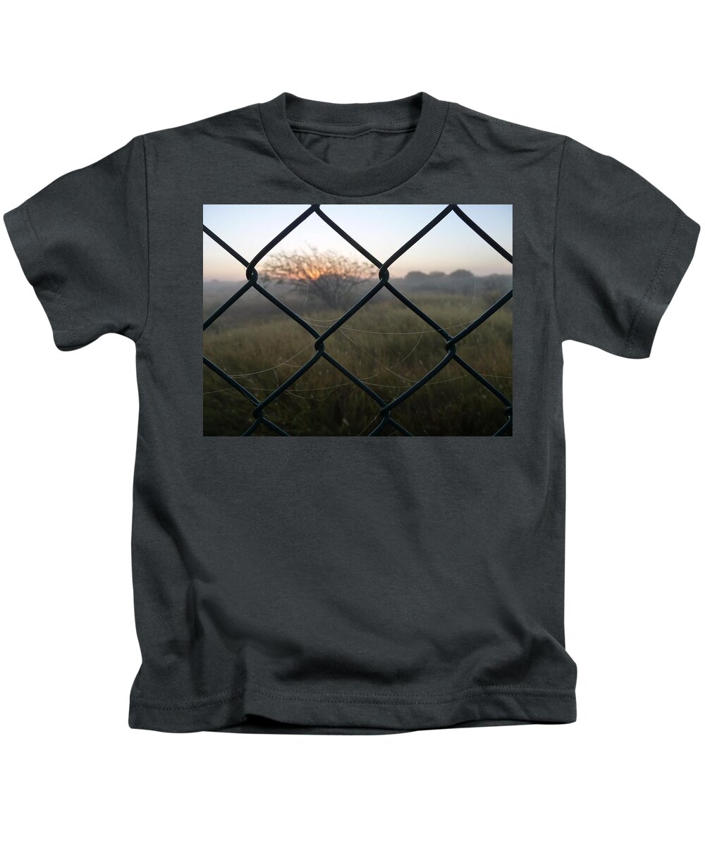 #fence Kids T-Shirt featuring the photograph The Outlander by Jeremy Holton