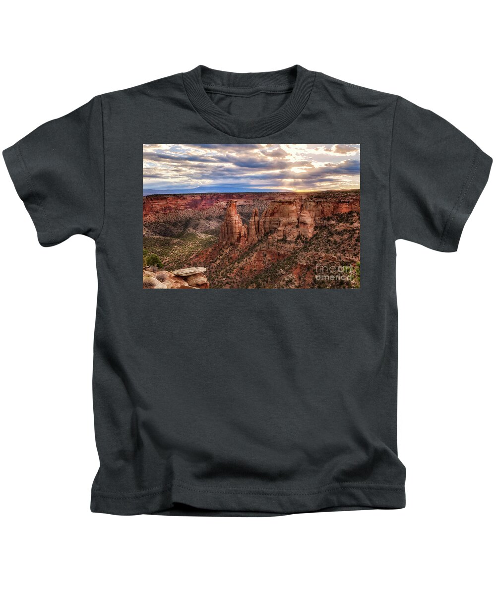 Colorado National Monument Kids T-Shirt featuring the photograph The Sun coming up over the Colorado National Monument by Ronda Kimbrow