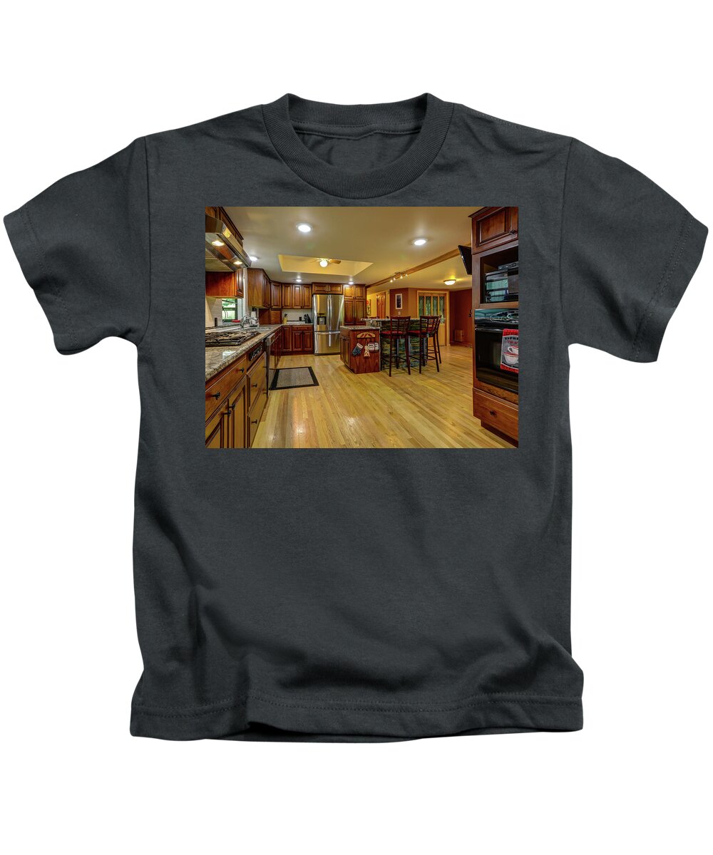 Real Estate Photography Kids T-Shirt featuring the photograph This is the kitchen and dining room of the Burns Rd Chalet by Jeff Kurtz