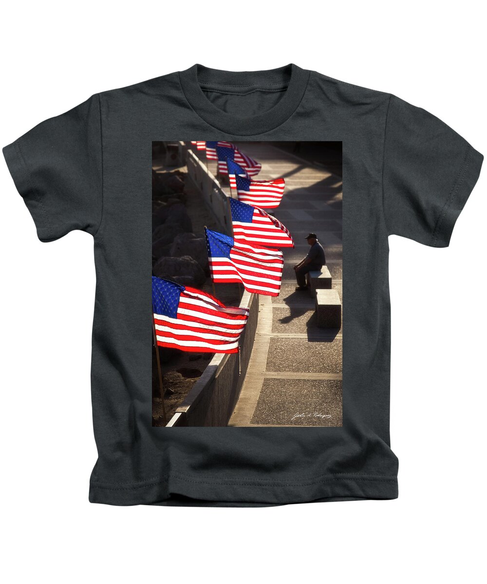 In Focus Kids T-Shirt featuring the photograph Veteran With Our Nations Flags by John A Rodriguez
