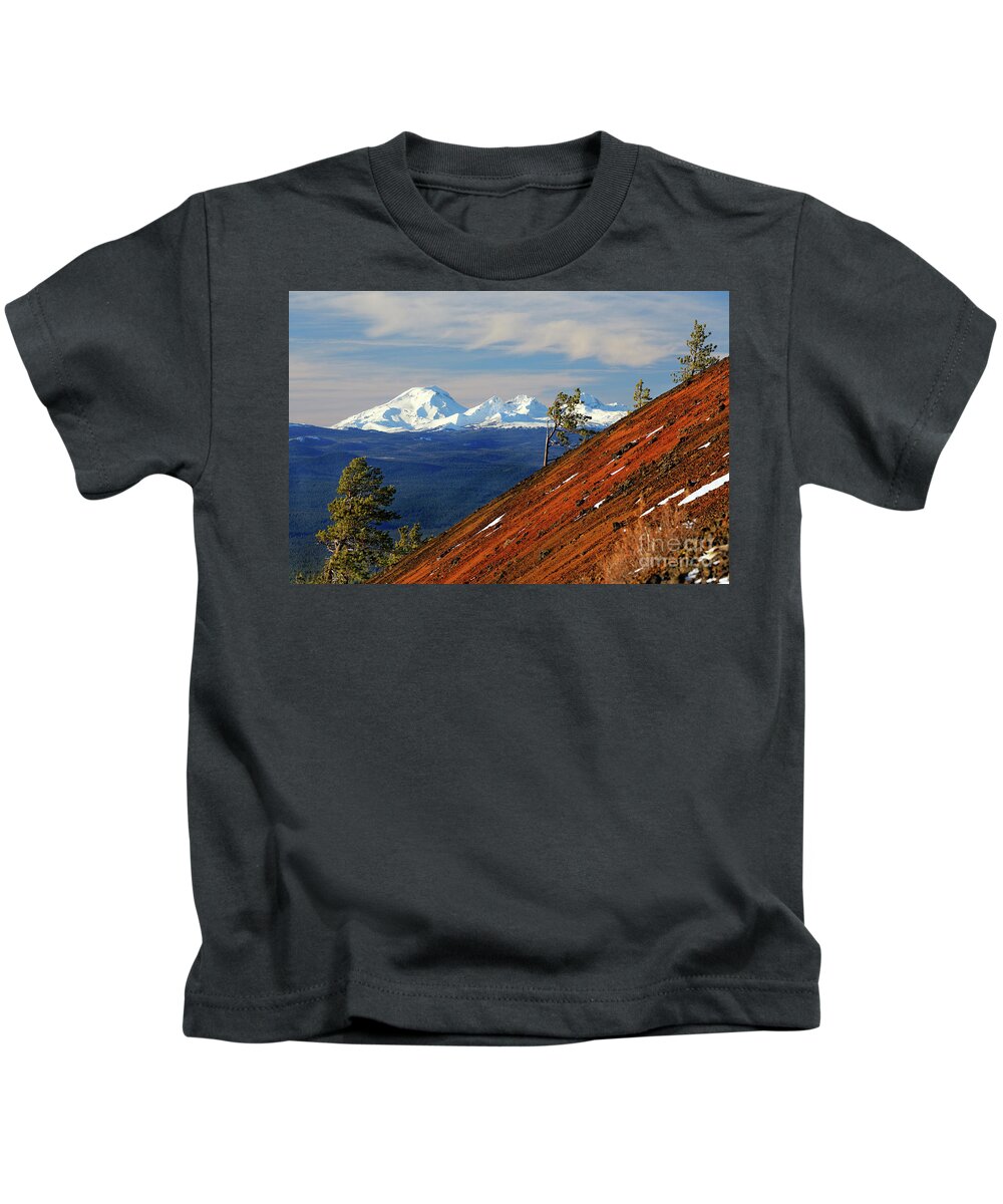 Summer Kids T-Shirt featuring the photograph Mokst Butte red cinder cone and distant snowy Cascade Mountains Mts and 3 Three Sisters Wilderness by Robert C Paulson Jr