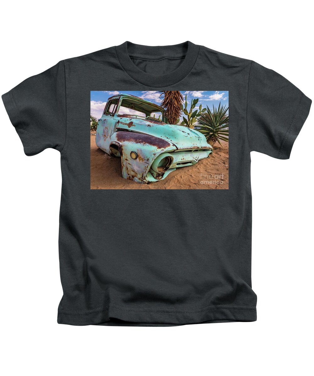 Car Kids T-Shirt featuring the photograph Old and abandoned car #7 in Solitaire, Namibia by Lyl Dil Creations