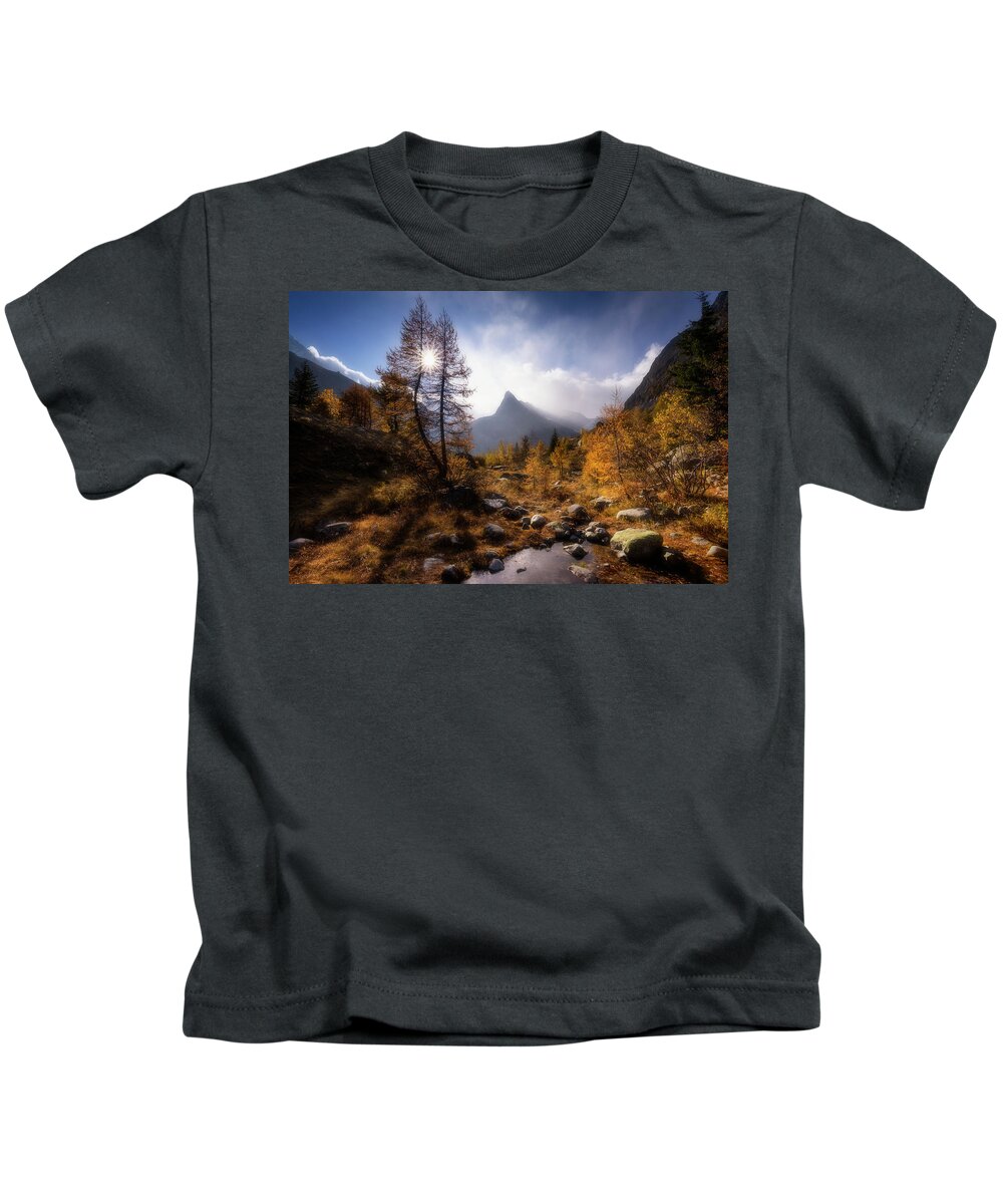 Water Kids T-Shirt featuring the photograph Sunstar through the trees by Dominique Dubied