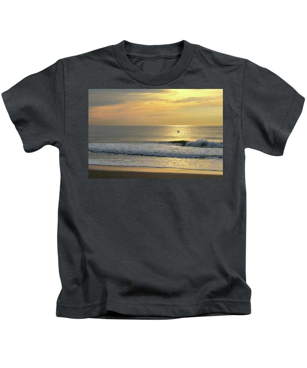 Jersey Shore Kids T-Shirt featuring the photograph Bird in Flight Over Ocean at Sunrise by Matthew DeGrushe