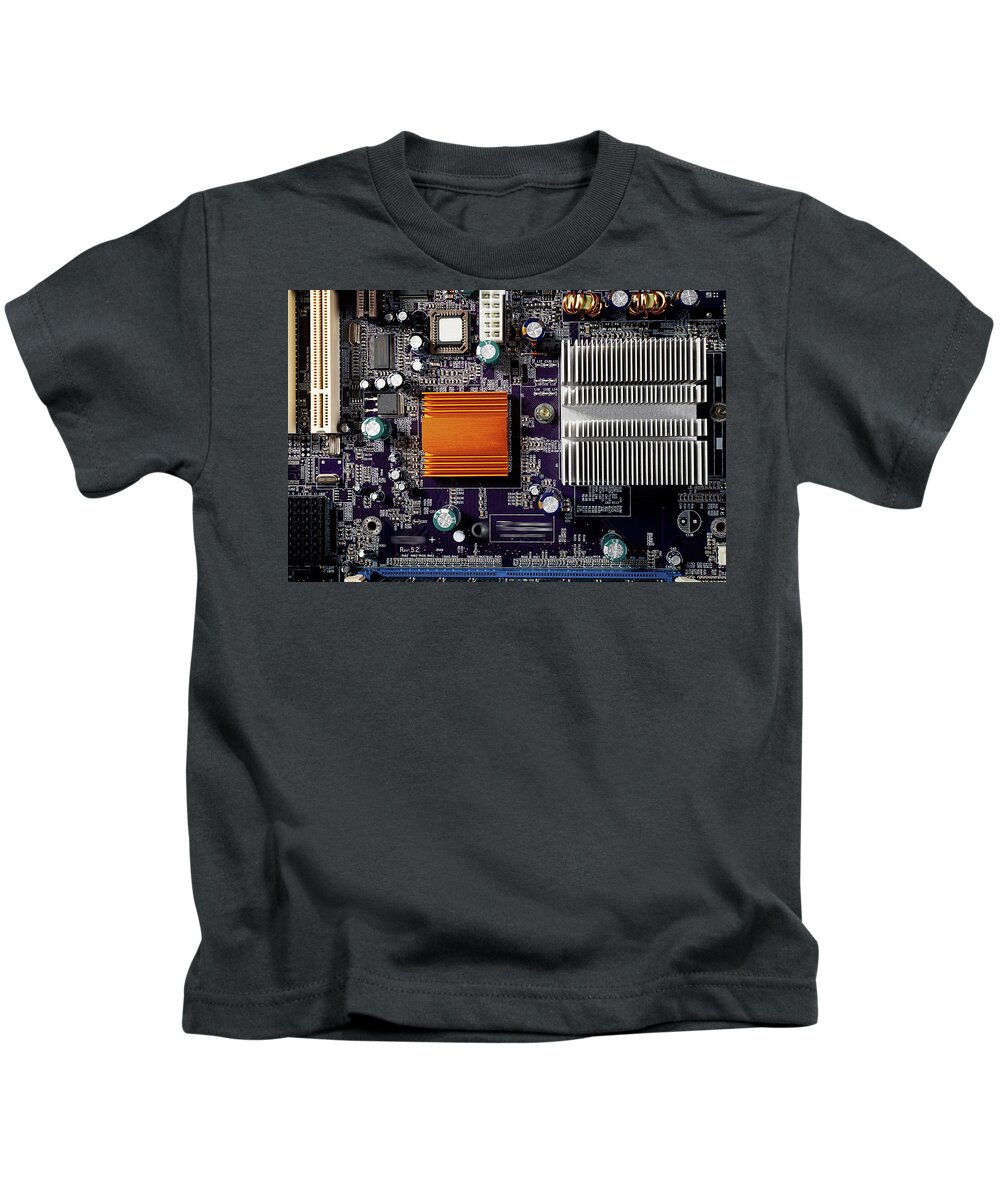 Computer Kids T-Shirt featuring the photograph Mainboard of a pc with electronic components. by Bernhard Schaffer