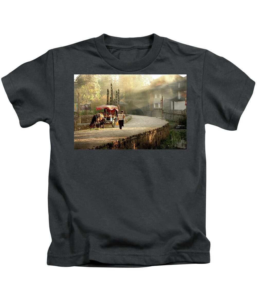 China Kids T-Shirt featuring the photograph Naxi Woman Leaving the Market by Mark Gomez